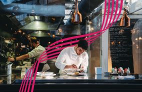 A chef is cooking in his restaurant's kitchen. High-end gourmet restaurant.