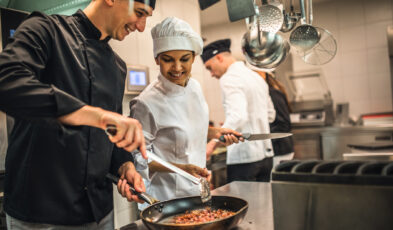 The team of cooks backs in the work in the modern kitchen,