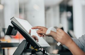 Team member using a till with receipt