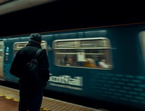 Man waiting for a train at Glasgow Central
